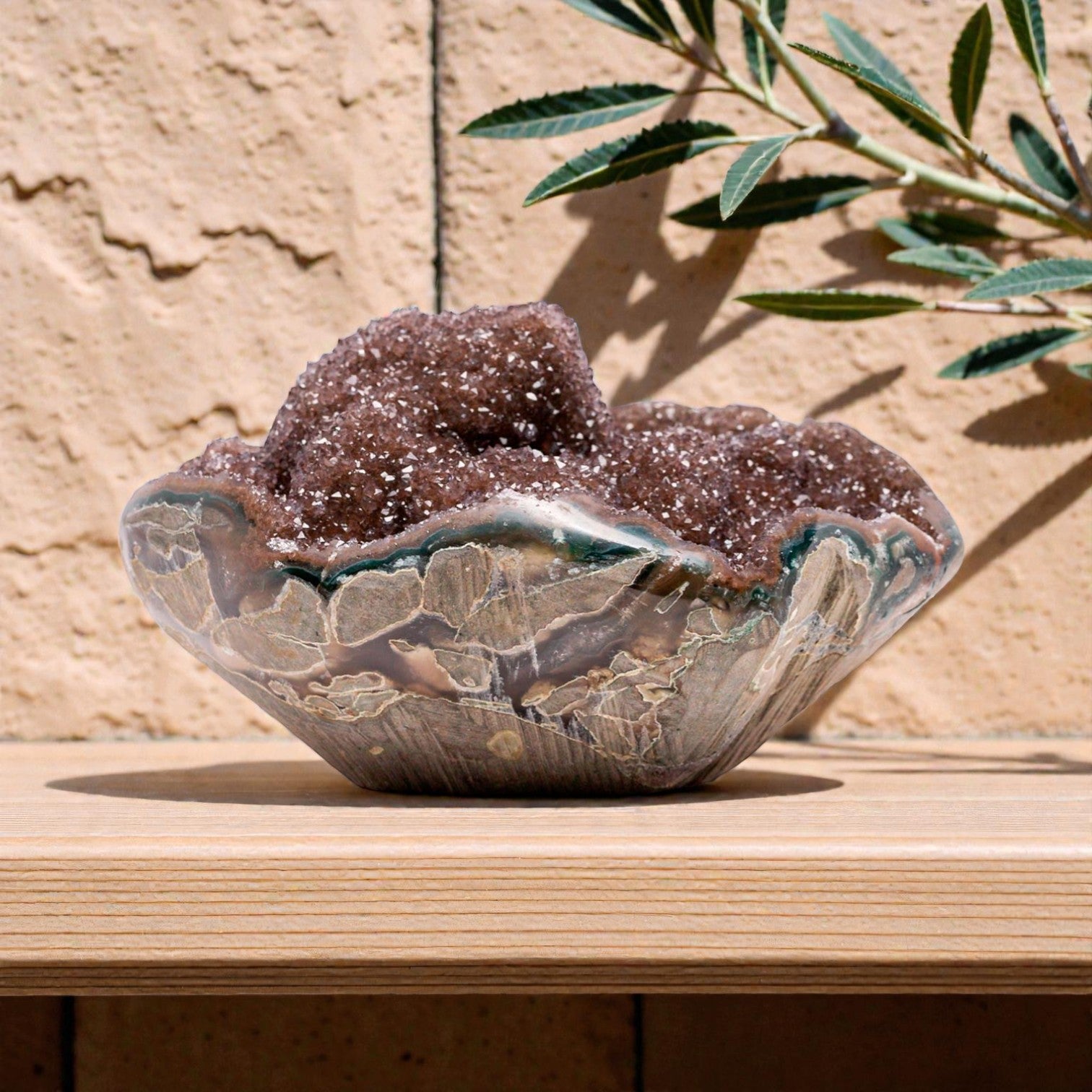 Small natural crystal geode featuring a sparkling reddish brown druzy quartz interior, layered agate banding, and organic volcanic formation in a compact decorative piece.