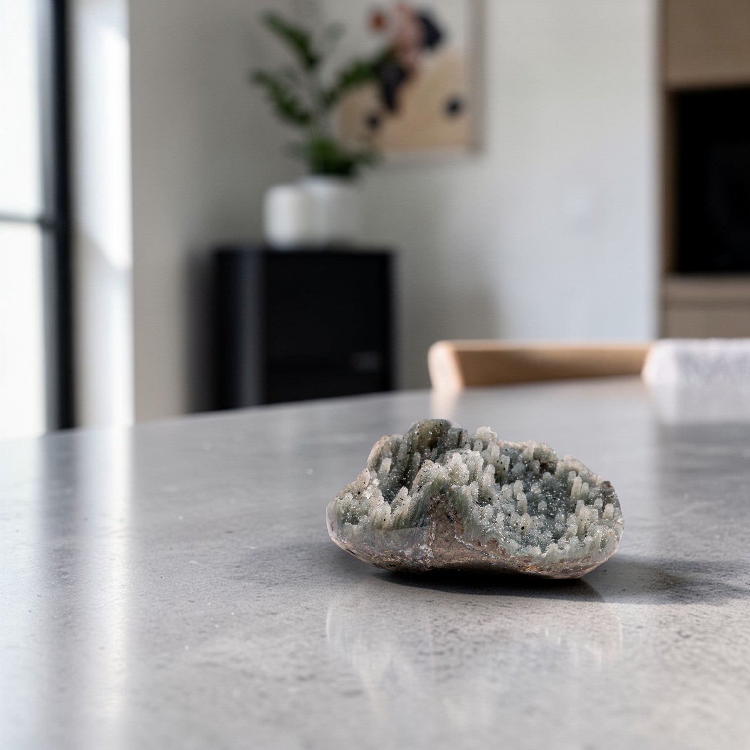 Small natural crystal geode displaying a grey quartz crystal cluster with fine druzy texture, organic chalcedony edges, and a raw mineral silhouette suited for luxury neutral decor.