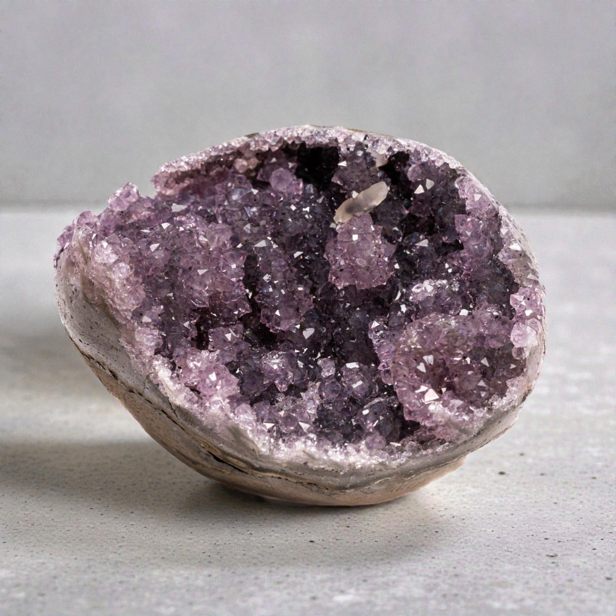 Mini amethyst geode with violet druzy quartz crystals with compact oval cavity - 1.36