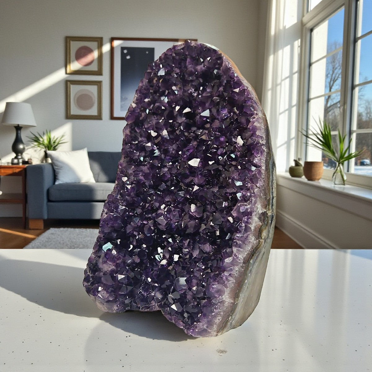 Upright amethyst cluster from Uruguay with rich purple crystals and strong light reflections highlighting its faceted surface.