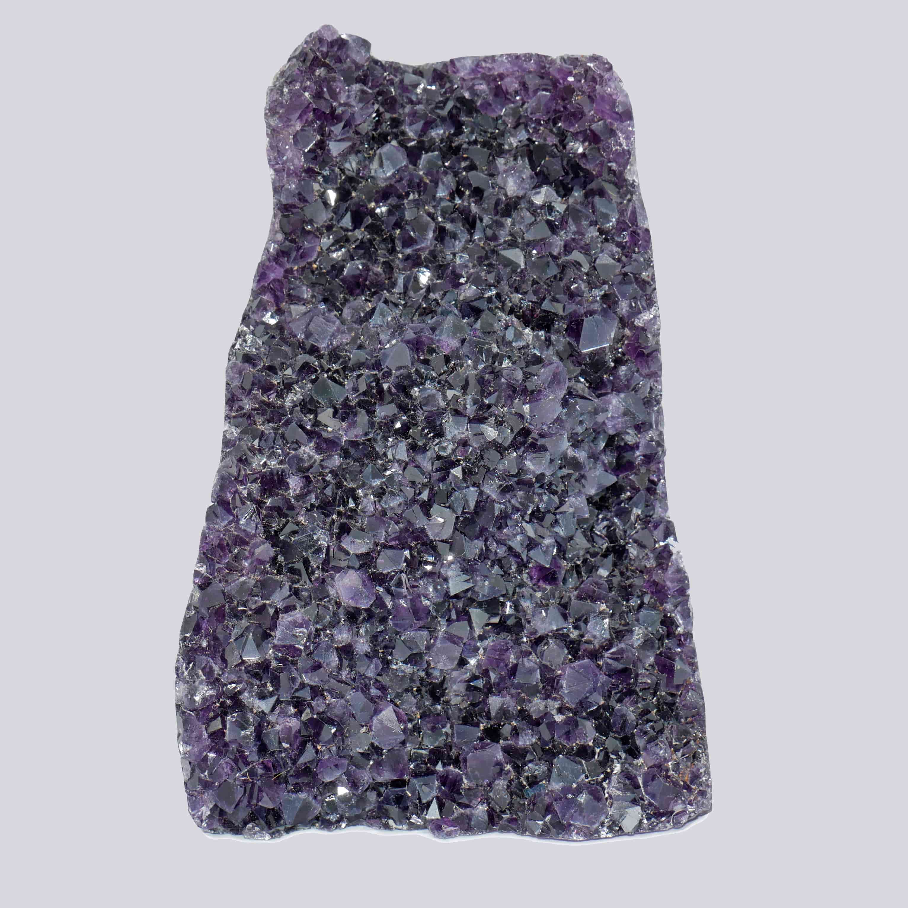 Flat-panel Uruguayan amethyst cluster with dense deep-purple crystal points and a natural raw-edge contour.