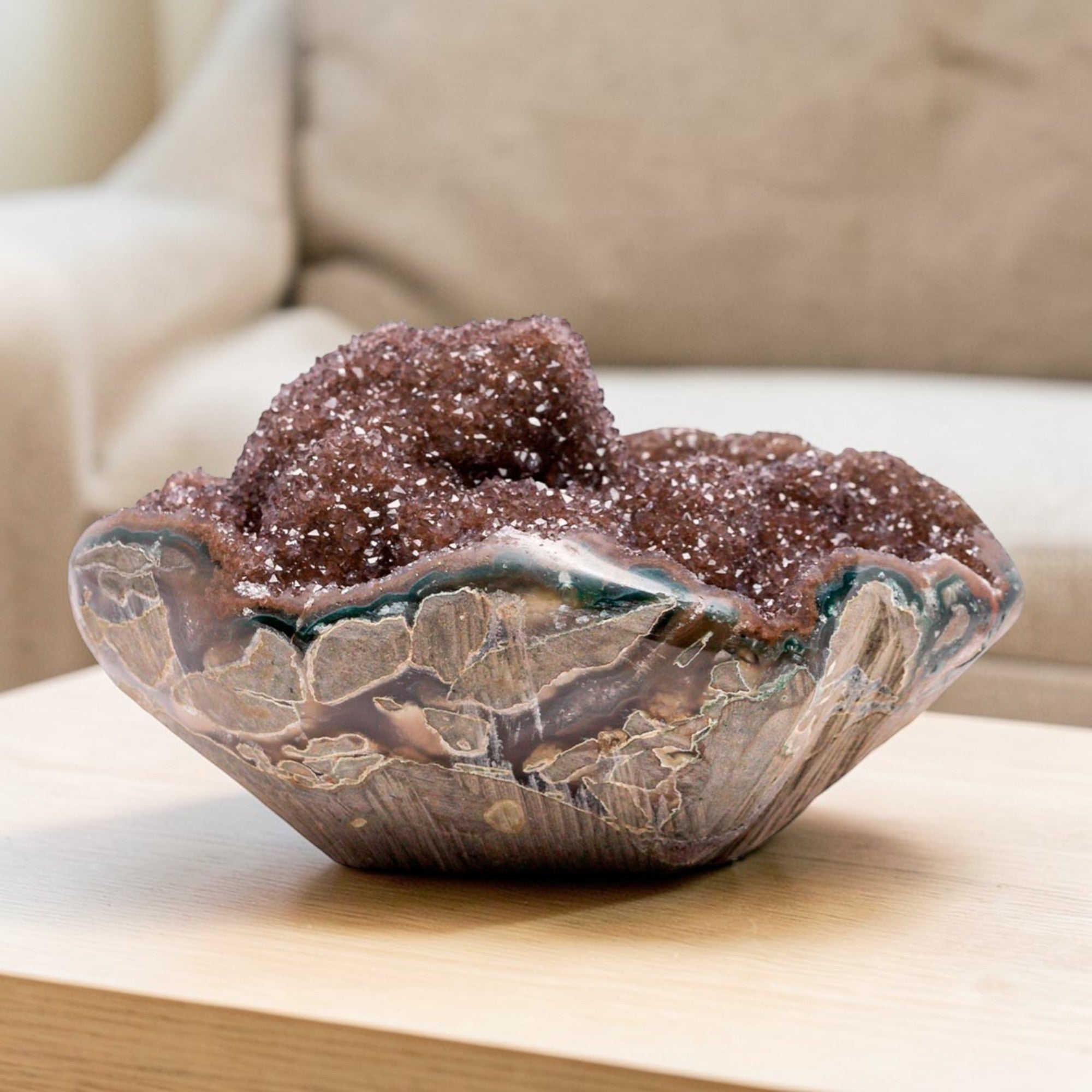 Mini druzy quartz geode with reddish brown crystal interior, strong banded agate layers, and visible chalcedony base, forming a sculptural hand-sized natural mineral specimen.