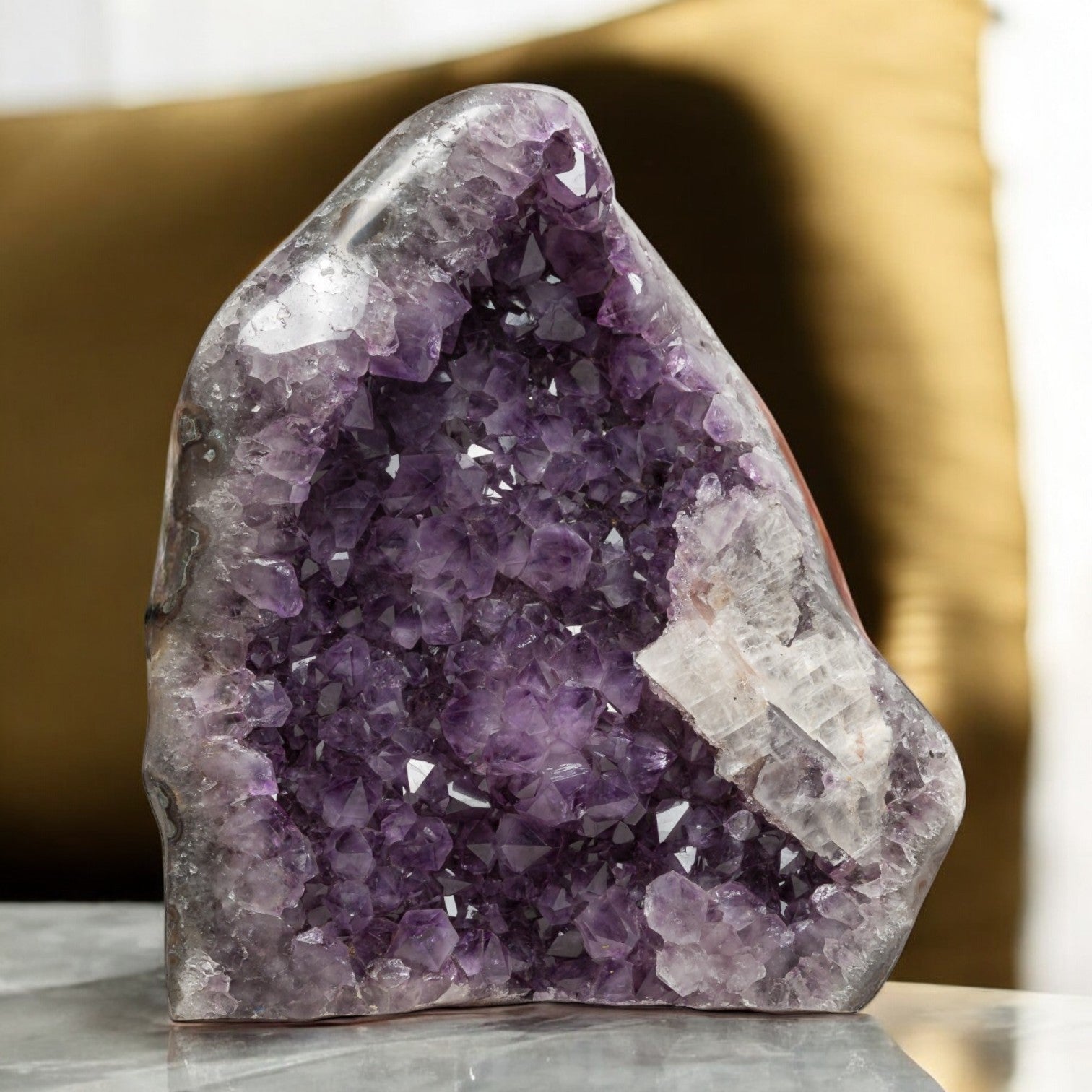 Uruguayan amethyst geode featuring rich violet crystals and a striking white quartz structure along the edge