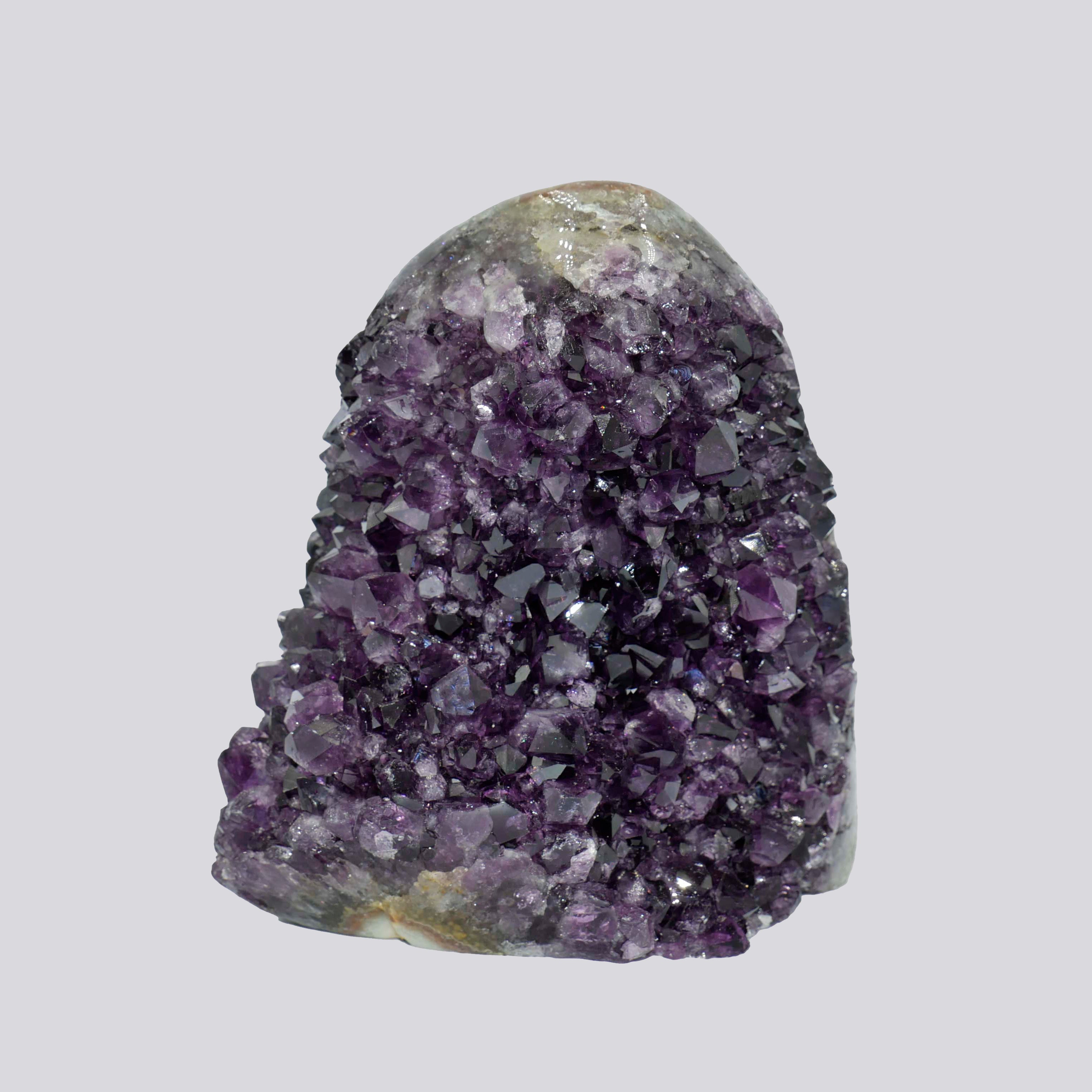 Tall deep-purple Uruguayan amethyst geode with dense crystal points and a natural rounded matrix top.