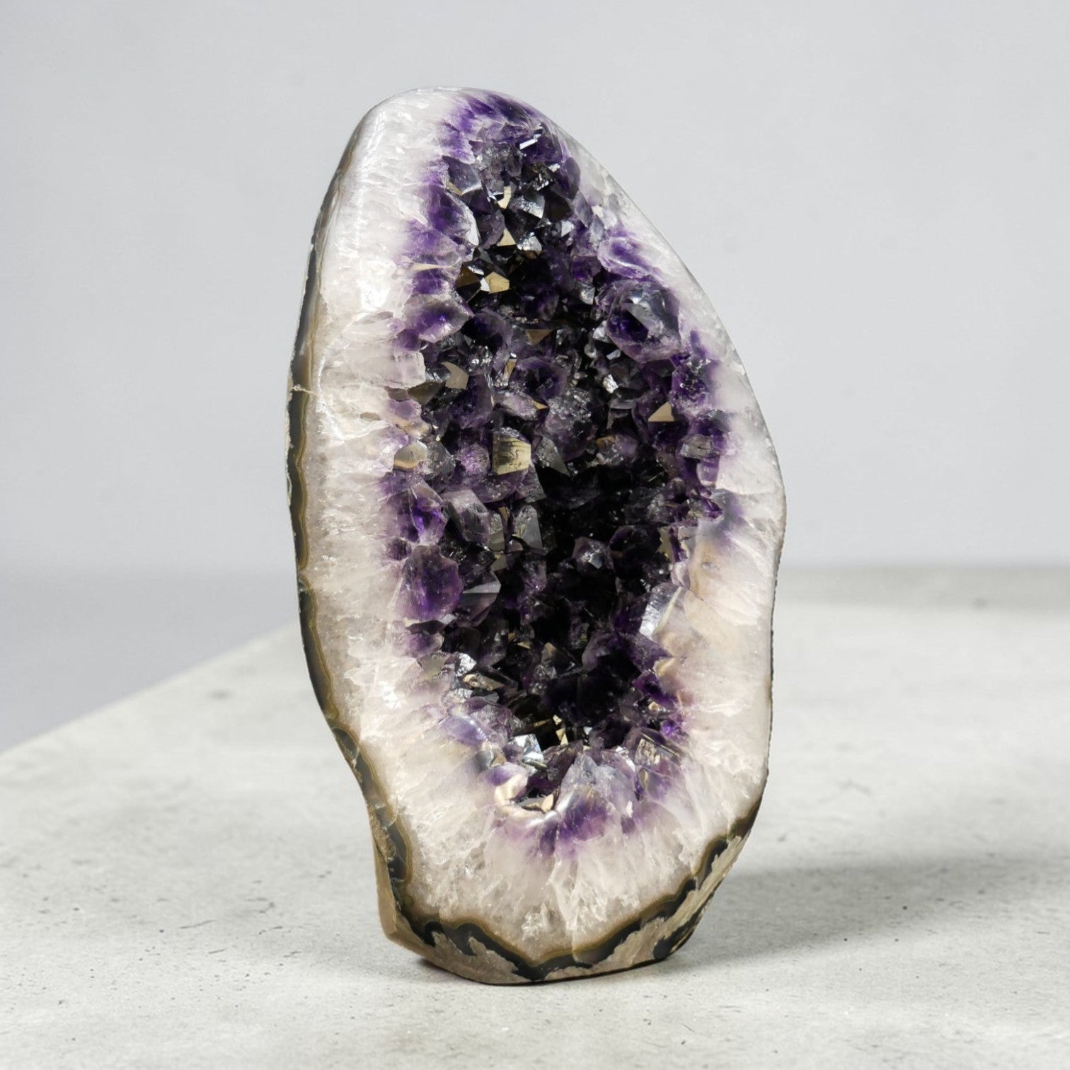 This natural amethyst geode egg is one of the rarest forms a Uruguayan amethyst can take. The egg shape is not cut or carved — it emerges from the rough through careful selection and polishing, preserving the raw crystal interior while revealing a seamless, tactile exterior. At 35.25 lb, it is a true statement amethyst piece: substantial, self-standing, and unmistakably Artigas.