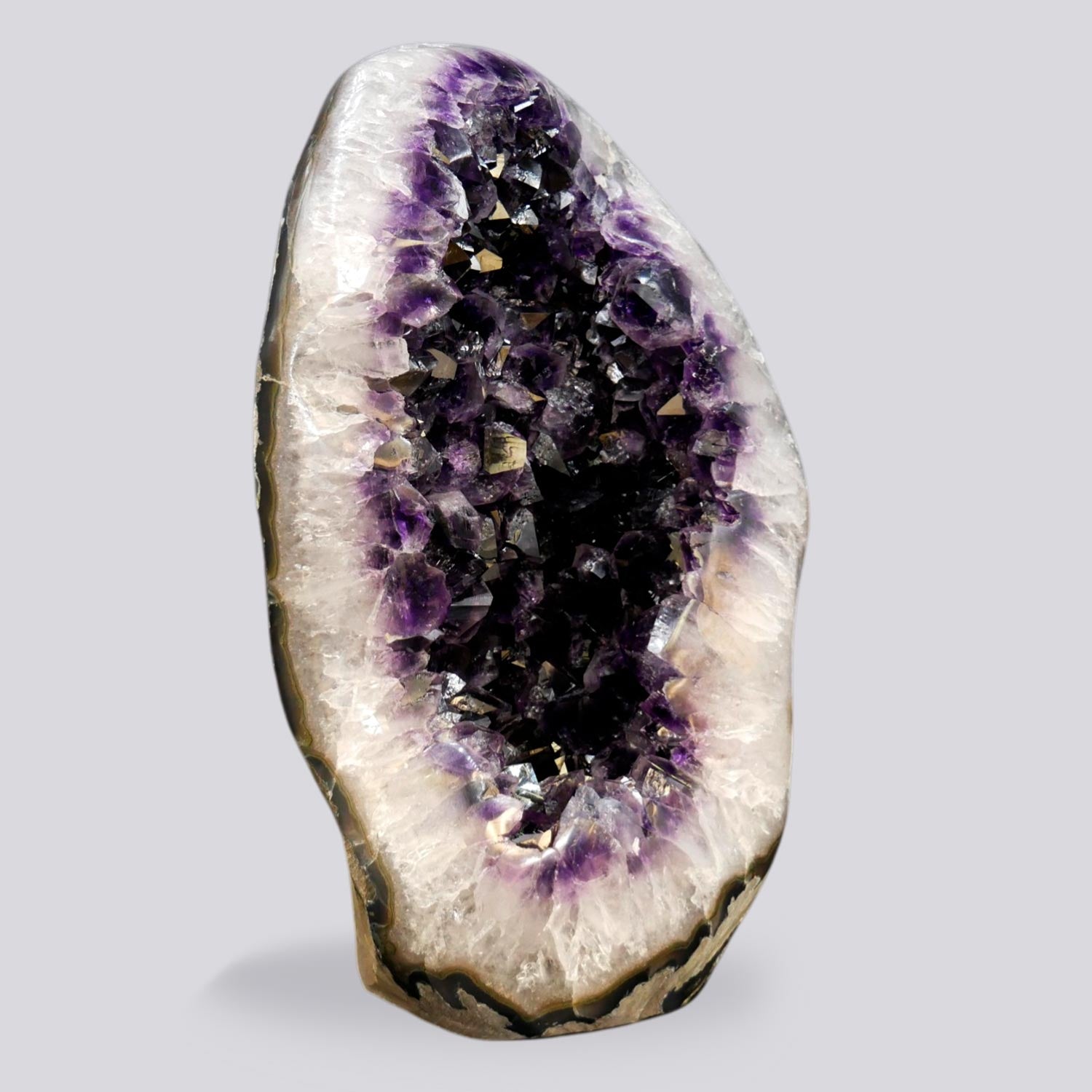 XL amethyst crystal egg 35.25 lb, deep purple near-black interior cavity with wide white quartz border, tall self-standing formation, Artigas Uruguay
