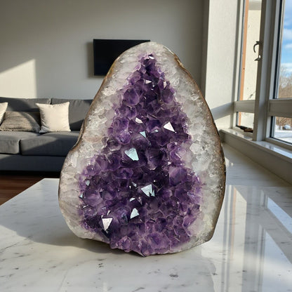 Front view of an amethyst crystal cluster featuring layered purple tones and a raw geode formation.
