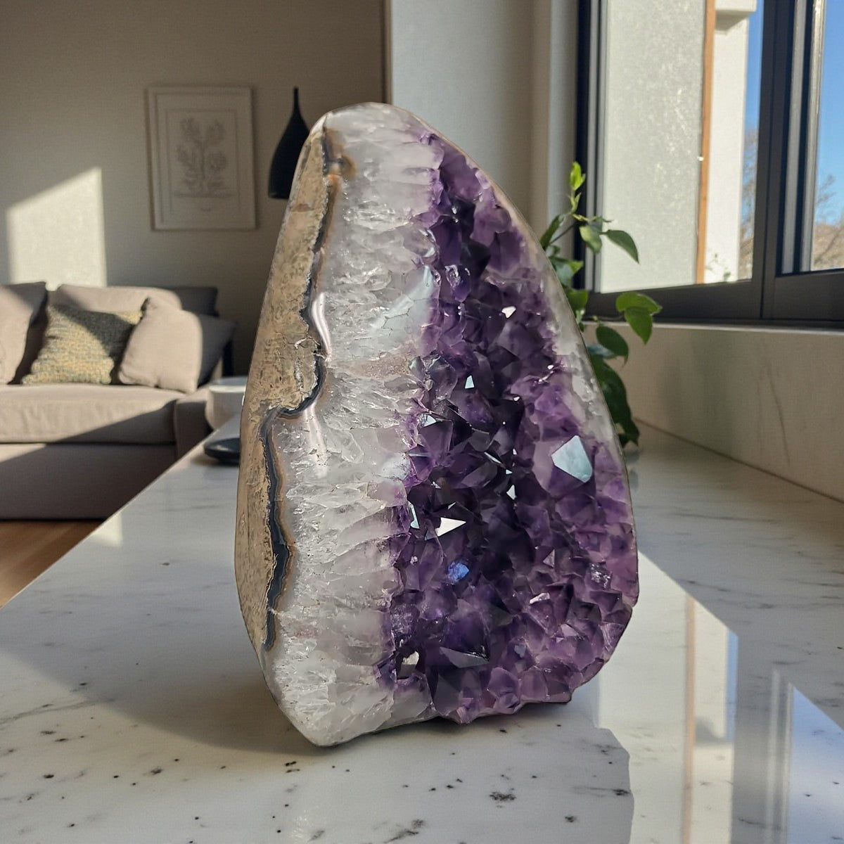 Uruguayan amethyst geode showing purple druzy crystals and multitone agate stripes along the exterior.