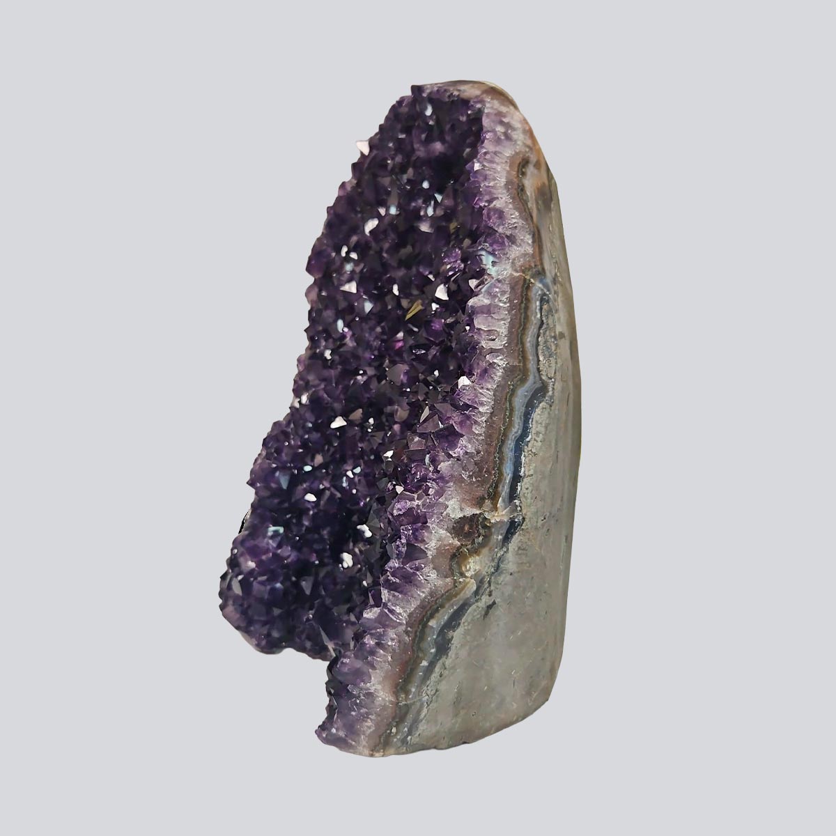 Tall Uruguayan amethyst geode with deep violet crystal points and layered agate banding, measuring 11 inches high by 7 long and 4 wide.
