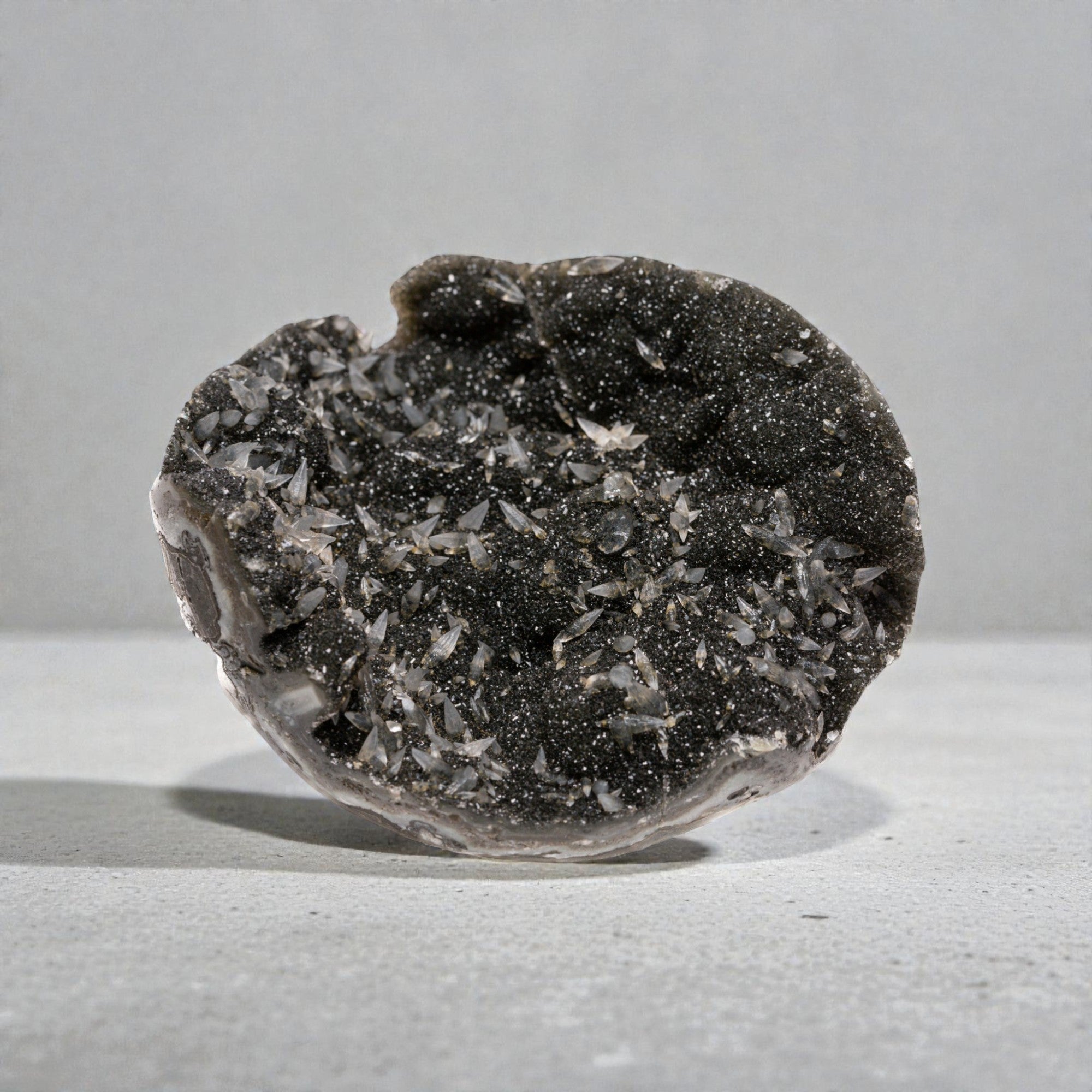 dark sugar amethyst with basalt quatz crystals. Sized hand