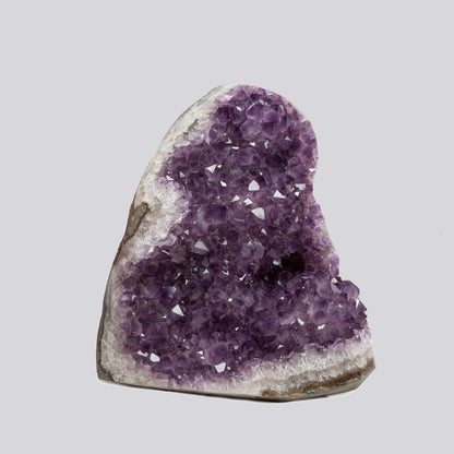 Deep purple Uruguayan amethyst geode with polished edge, natural crystal cluster standing upright for home decor and energy cleansing.