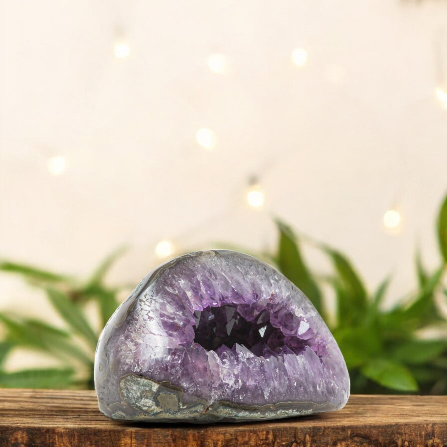 Dome-shaped amethyst geode from Uruguay featuring a dark central cavern and shimmering purple crystal bands.”