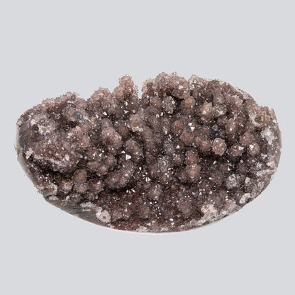 Small hand-size amethyst cluster in brown and rose tones with rounded crystal formations and a sparkling textured surface.