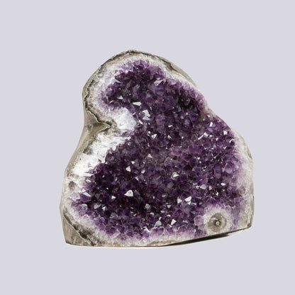 Large deep-purple amethyst cluster from Uruguay with shimmering crystal facets, a natural statement piece for home decor.