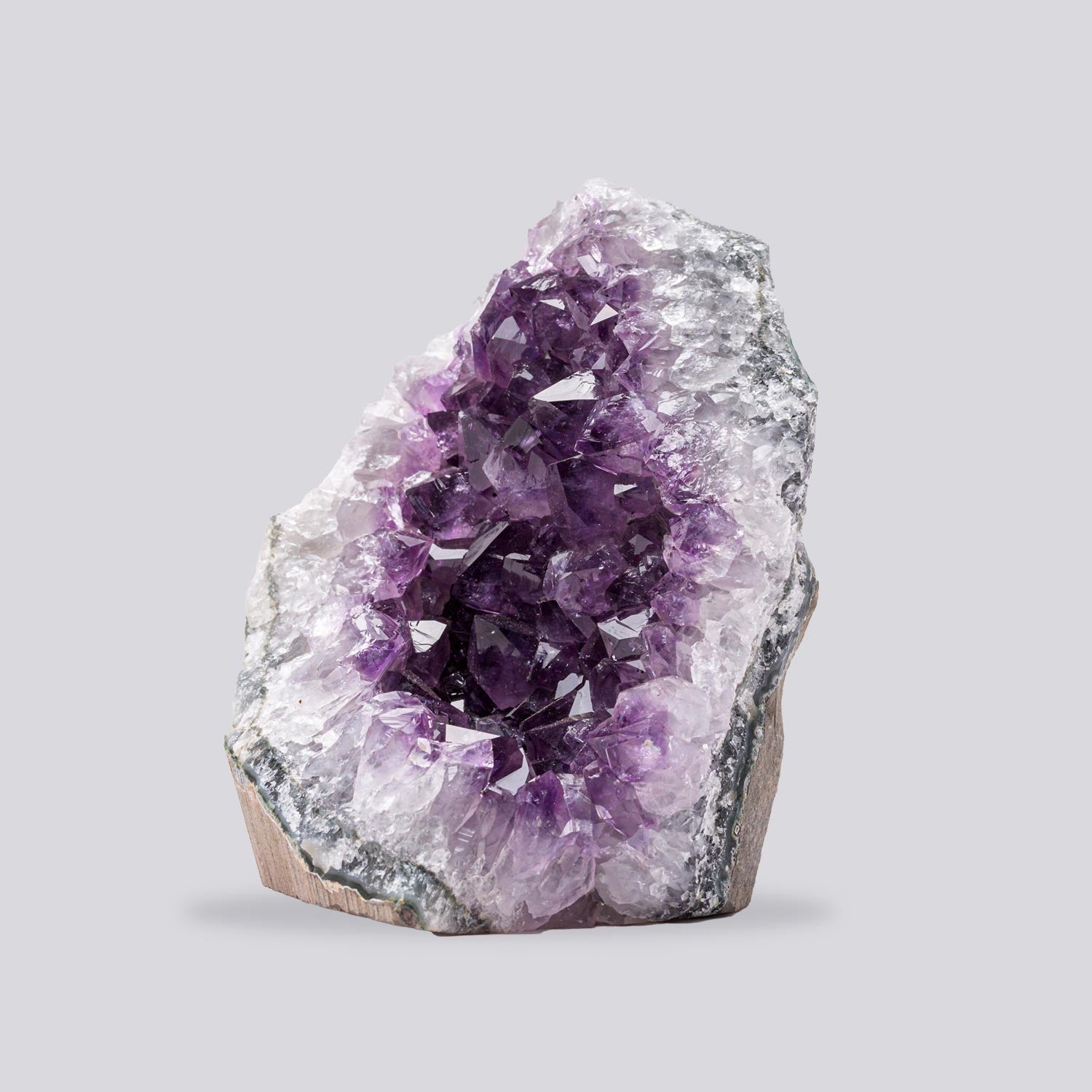 Side view of authentic Uruguay amethyst cluster under 1 lb highlighting dense crystal points and rich violet color.