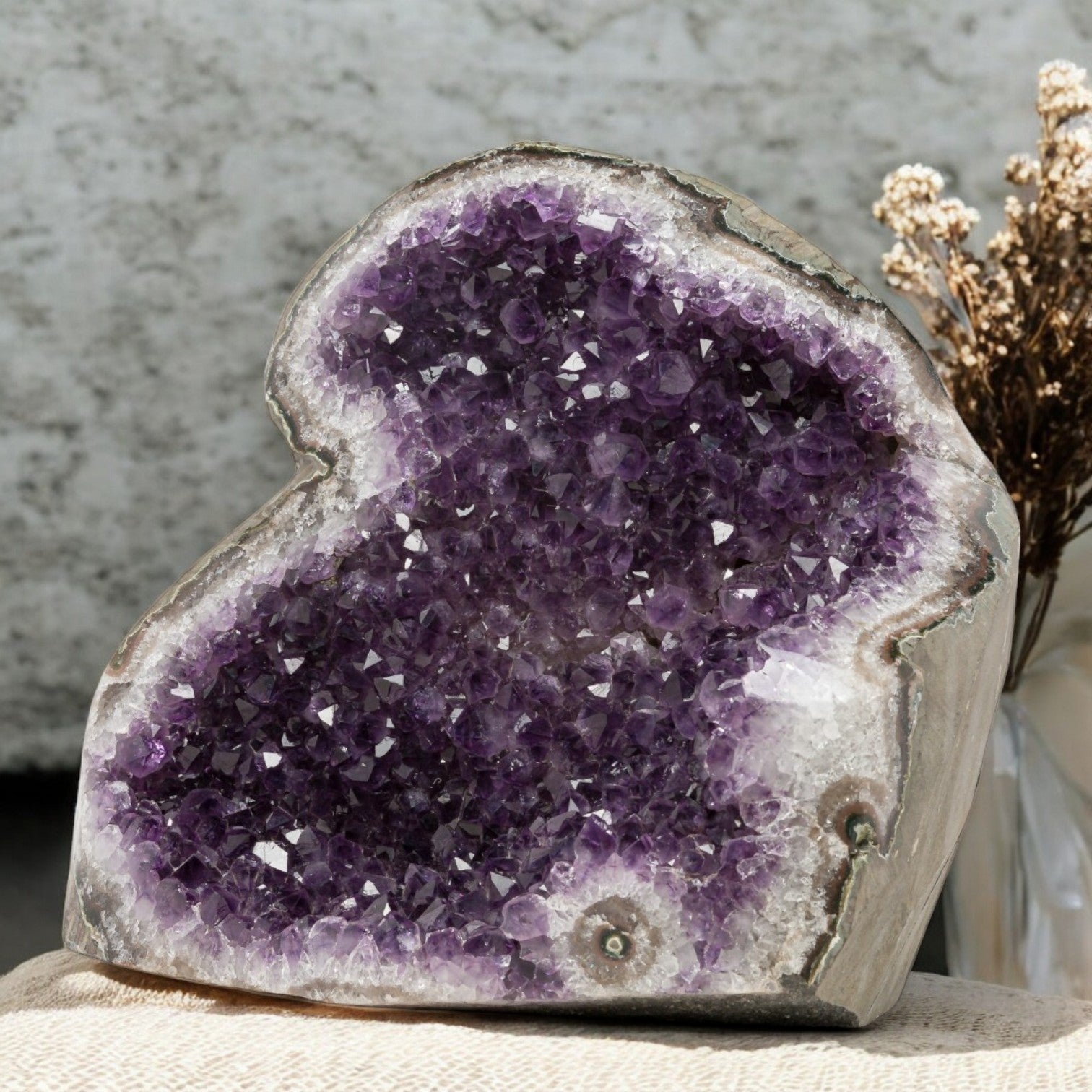 Bold deep-purple amethyst geode with sparkling crystal texture and natural quartz contouring, ideal for elevated home styling.