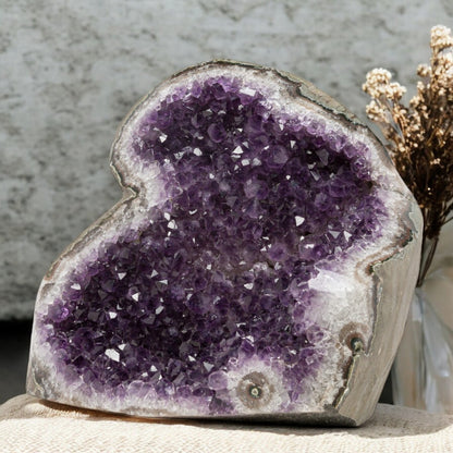 Bold deep-purple amethyst geode with sparkling crystal texture and natural quartz contouring, ideal for elevated home styling.