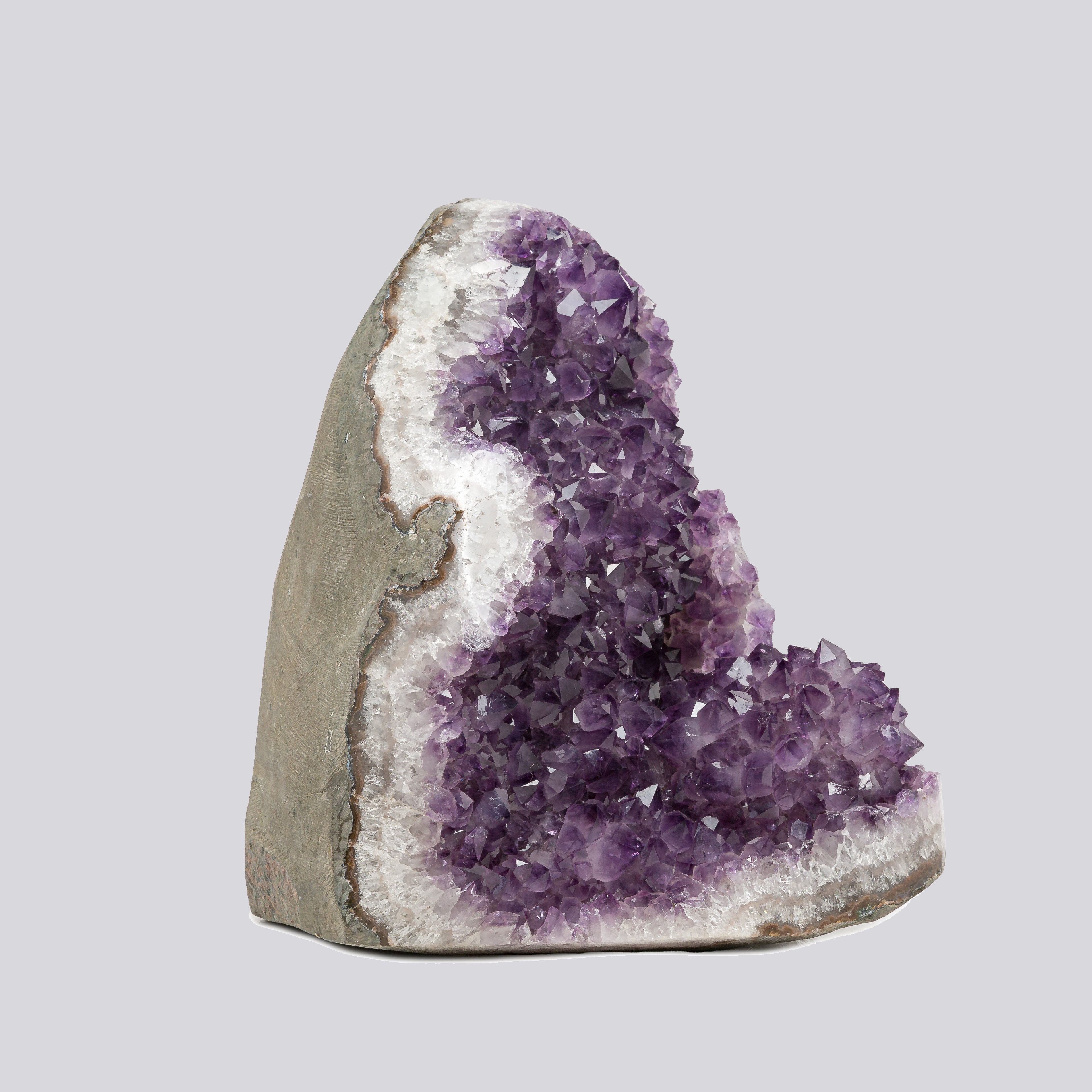 Hand-selected Uruguayan amethyst geode displaying vibrant purple crystals and white quartz edges, ideal for luxury home decor or altar styling.